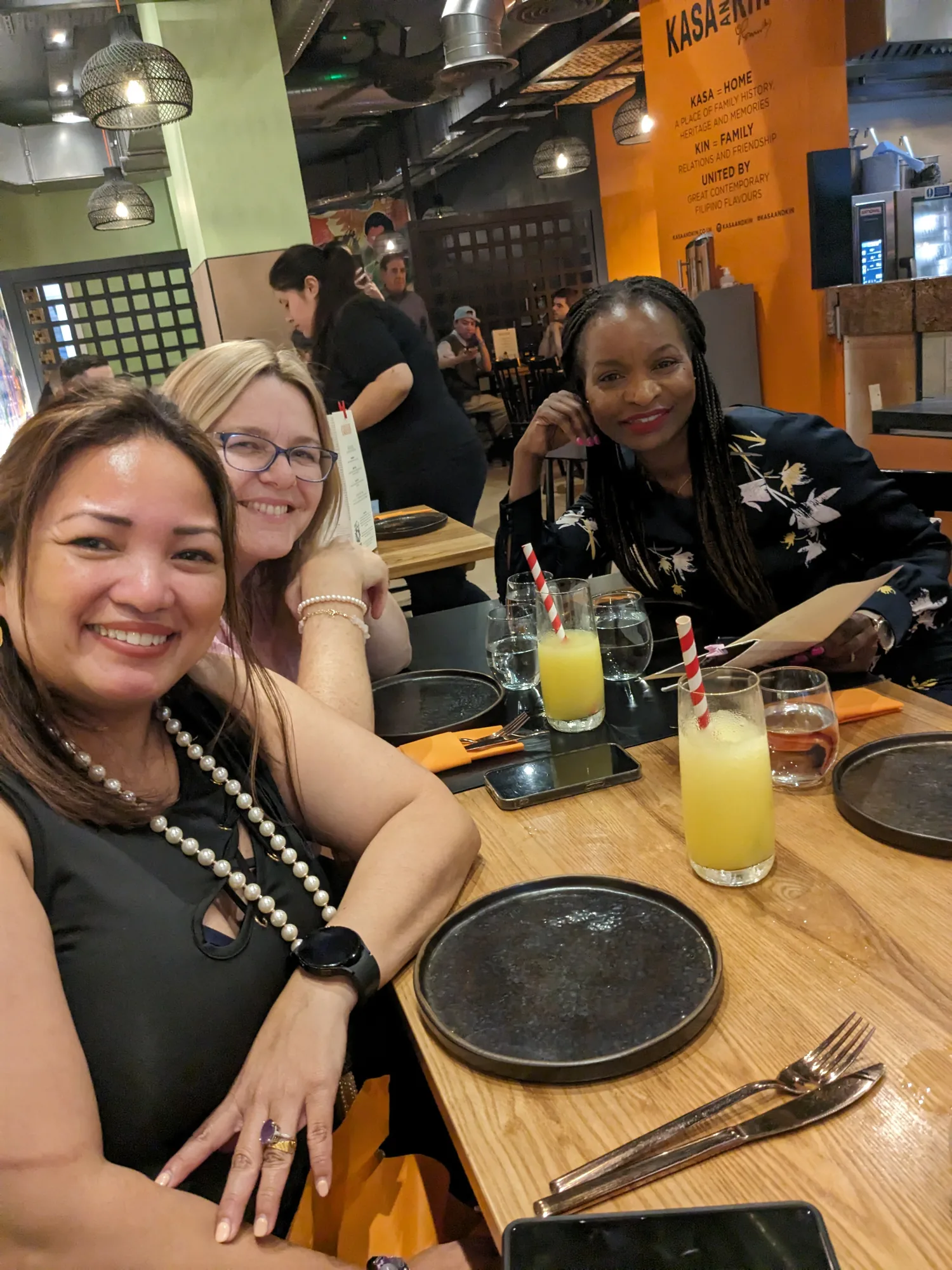 Crystal Dias, Marianne Layson and Irene Kamya at a team dinner